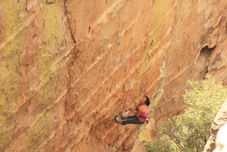 TUCSON, ARIZONA, USA --April 19, 2014:  Woman with a look of anguish is resting from lead rope climbing a hoodoo near Windy Point on Mount Lemmon in Tucson, Arizona, USA in the Santa Catalina Mountains located in the Coronado National Forest with copy spaのeditorial素材