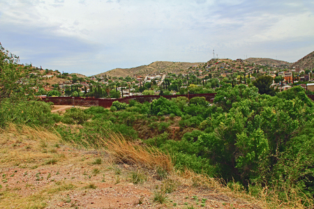 Border Fence beside a road near Nogales, Arizona separating the United States from Mexico.の写真素材