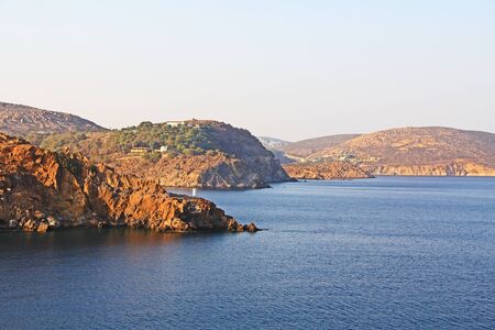 View of the island of Patmos, Greece in the Aegean Sea where St. Paul wrote the book of Revelation in the Bible with beautiful blue sky and water copy space.の写真素材