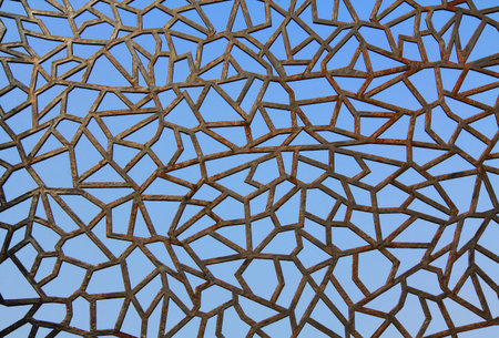 Rusty metal abstract fence background texture against a blue sky in Kusadasi, Turkey.