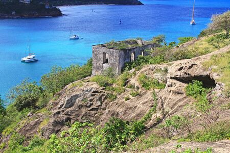 Block guard house overlooking Deep Bay near Old Fort Barrington, Five Islands Peninsula between Deep Bay and St. Johnâs Harbour, Antigua Barbuda Lesser Antilles, West Indies, Caribbean, Goat Hill.の写真素材