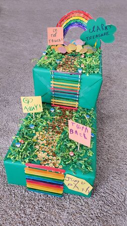 Colorful DIY Leprechaun Trap made by a child and Mom for a school project with, rainbow, ladder, path, signs, path and gold coins.の写真素材