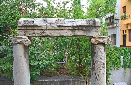 Looking down into an excavated area you will see an old historic marble column doorway located in downtown Athens, Greece.の写真素材