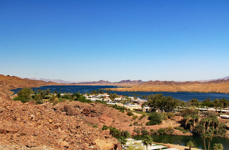 View of Lake Havasu and Colorado River with homes near Lake Havasu City, Arizona, USA with view of California and blue sky.の写真素材