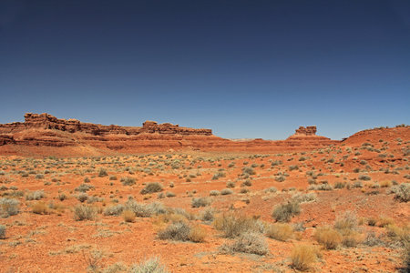 Red rock butte formation in Utah, USA in San Juan County, Monument Valley, on the Navajo Nation Reservation with blue sky copy space.の写真素材