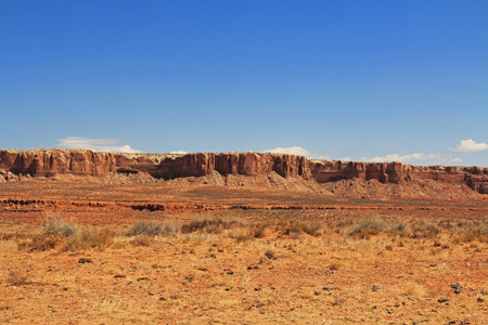 Red rock butte formation in Utah, USA in San Juan County, Monument Valley, on the Navajo Nation Reservation with blue sky.の写真素材