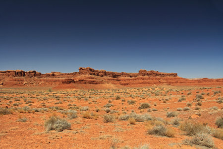 Red rock butte formation in Utah, USA in San Juan County, Monument Valley, on the Navajo Nation Reservation with blue sky.の写真素材
