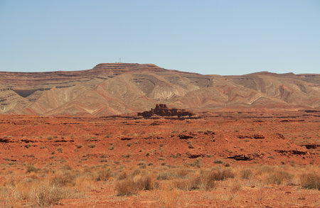 Mountains with outcropping In Monument Valley near Mexican Hat, red rock formation in Southern Utah, US, San Juan County, on the Navajo Nationâs borders, with blue sky and rocky coの写真素材