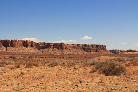 Red rock butte formation in Utah, USA in San Juan County, Monument Valley, on the Navajo Nation Reservation with blue sky.の写真素材