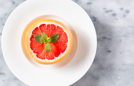 Overhead View of Fresh Grapefruit Half with Mint Sprigの写真素材