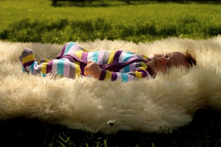 one month old baby on the grassの写真素材