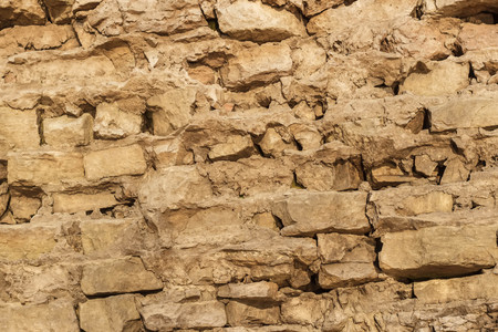 Stone wall from partially destroyed old masonry. Close planの写真素材