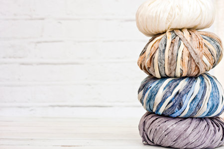 Yarns in basket with crochet hooks in harmonious colors. knitting, crocheting supplies.