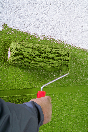 White facades painting with paint roller - hand applyingの写真素材