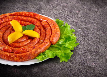 Raw domestic stuffed sausage in plateの写真素材