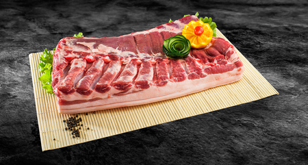 Fresh and raw bacon ribs on kitchen table ready for bbq or grill with clipping pathの写真素材