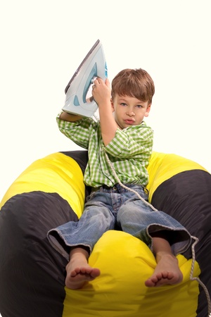 mischievous boy in the studio playing with ironの写真素材