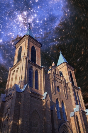 stars and billions of galaxies shining in the night over the old churchの写真素材