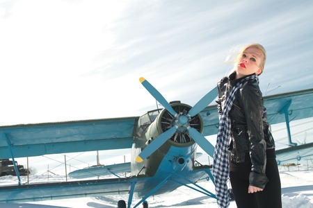 sexy young girl next to the pilot vintage aircraftの写真素材