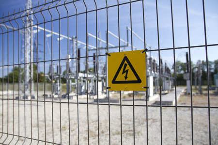 Electricity sign hanging on the fence