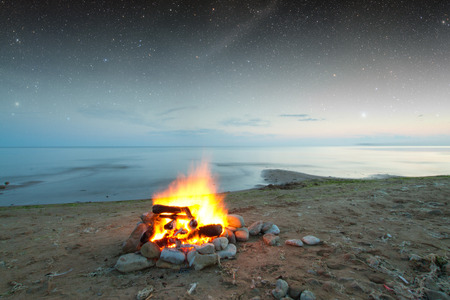 Inviting campfire on the beach during the summer. の写真素材
