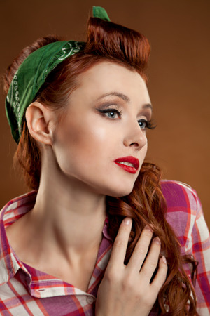 pin-up girl. beautiful young woman isolated on white in studio in old fashion clothes representing pinup and retro styleのeditorial素材