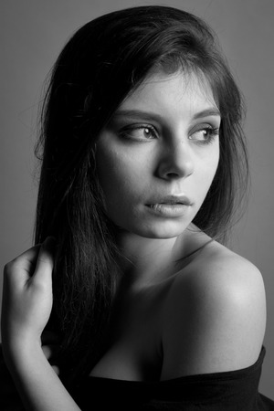 black and white photo. Beautiful caucasian brunette woman with long shiny brown hair and clean skin. Portrait of a fashion model in studioの写真素材