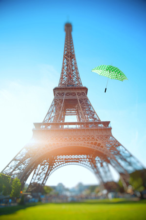 umbrella flying through the air against the backdrop of the Eiffel Tower. Summer trip to France in Paris.の写真素材