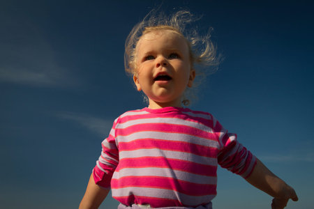 little girl walking by the sea. summer vacation by the ocean