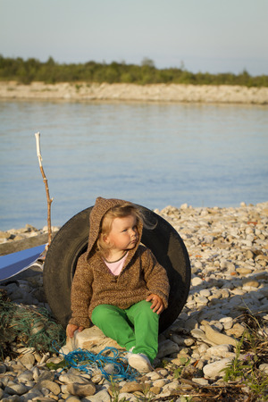 Girl in the autumn at the sea . standing against the evening seaの写真素材