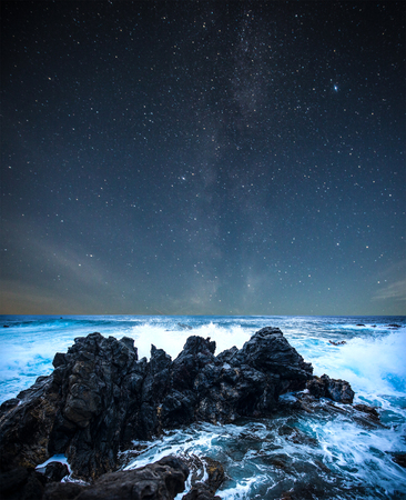 stars in the sky over the sea shine at night.の写真素材