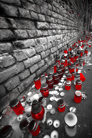 candle stand on the street near the wall. black and white photo with the color redの写真素材