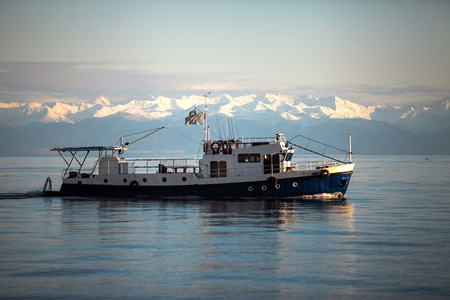 ship at the Baikal lake in siberia, Russia, mountains backgroundの写真素材