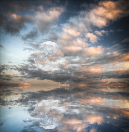 Shines a big moon shines over the calm seaの写真素材