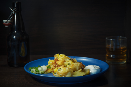 Fried potato sliced slices on a plate on a neutral backgroundの写真素材