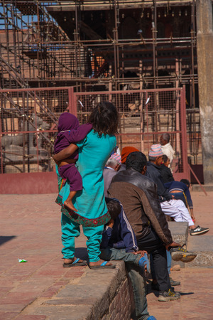 BHAKTAPUR, NEPAL - DECEMBER 14, 2017: Portrait of Nepalese girl playing at Durbar squareのeditorial素材