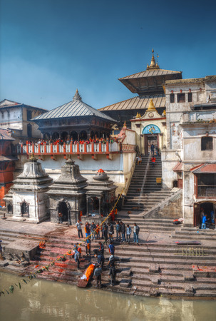 Kathmandu, Nepal - November 22, 2016: The cremation ceremony along the holy Bagmati River in Bhasmeshvar Ghat at Pashupatinath temple in Kathmandu.のeditorial素材