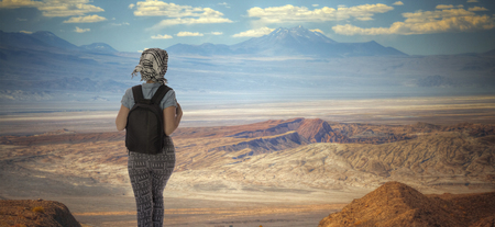 a tourist girl is traveling with a backpack in the Atacama Desert.の写真素材