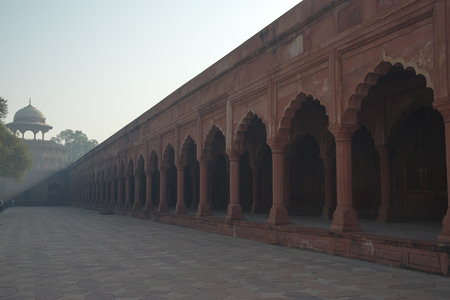 gate through which the Taj Mahal visitors in a park that surrounds the mausoleumの写真素材