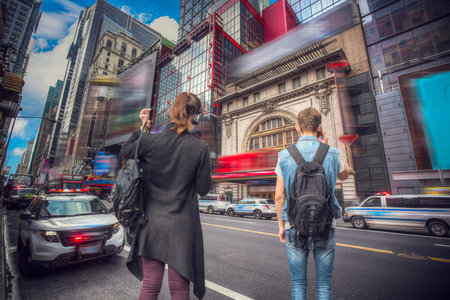 In Manhattan, a man is talking on the phone, a woman is crossing the road