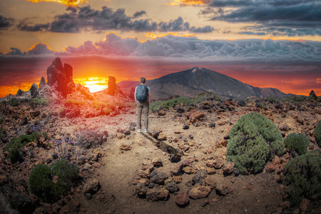 A man walks against the background of the volcano Teide. Tenerife.の写真素材