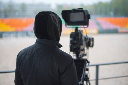 Man with a tv camera at sporting events
