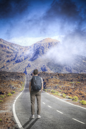 A man walks against the background of the volcano Teide. Tenerife.の写真素材