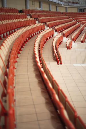 sports tribunes. Empty colored chairs at the stadiumの写真素材