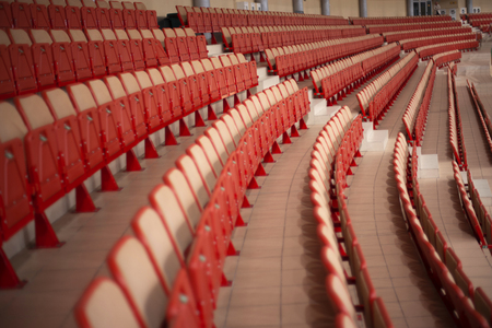 sports tribunes. Empty colored chairs at the stadiumの写真素材