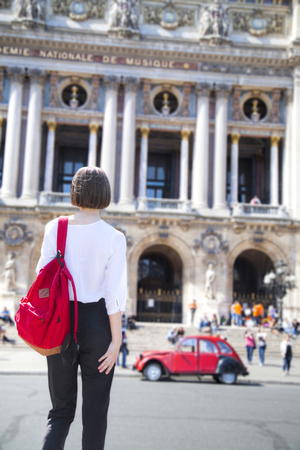 A woman walks through the streets of Parisの写真素材