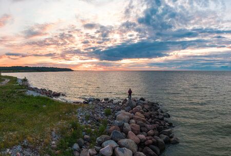 man at sunset by the sea. Shot on droneの写真素材