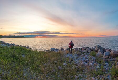 man at sunset by the sea. Shot on droneの写真素材