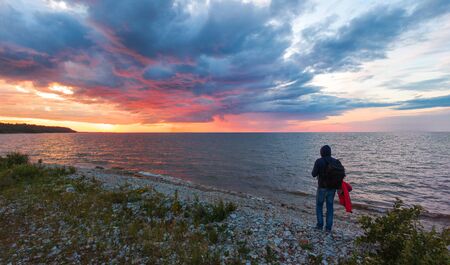man at sunset by the sea. Shot on droneの写真素材