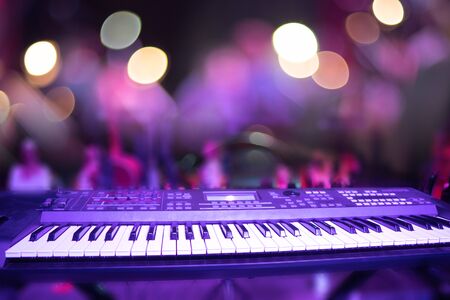 Fingers keyboardist on the background of the guitarist.の写真素材